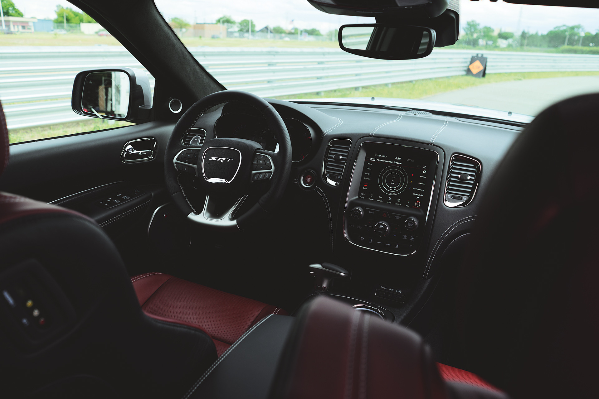 2019 Dodge Durango interior view of SRT cockpit, showing steering wheel and full-colour in-cluster display
