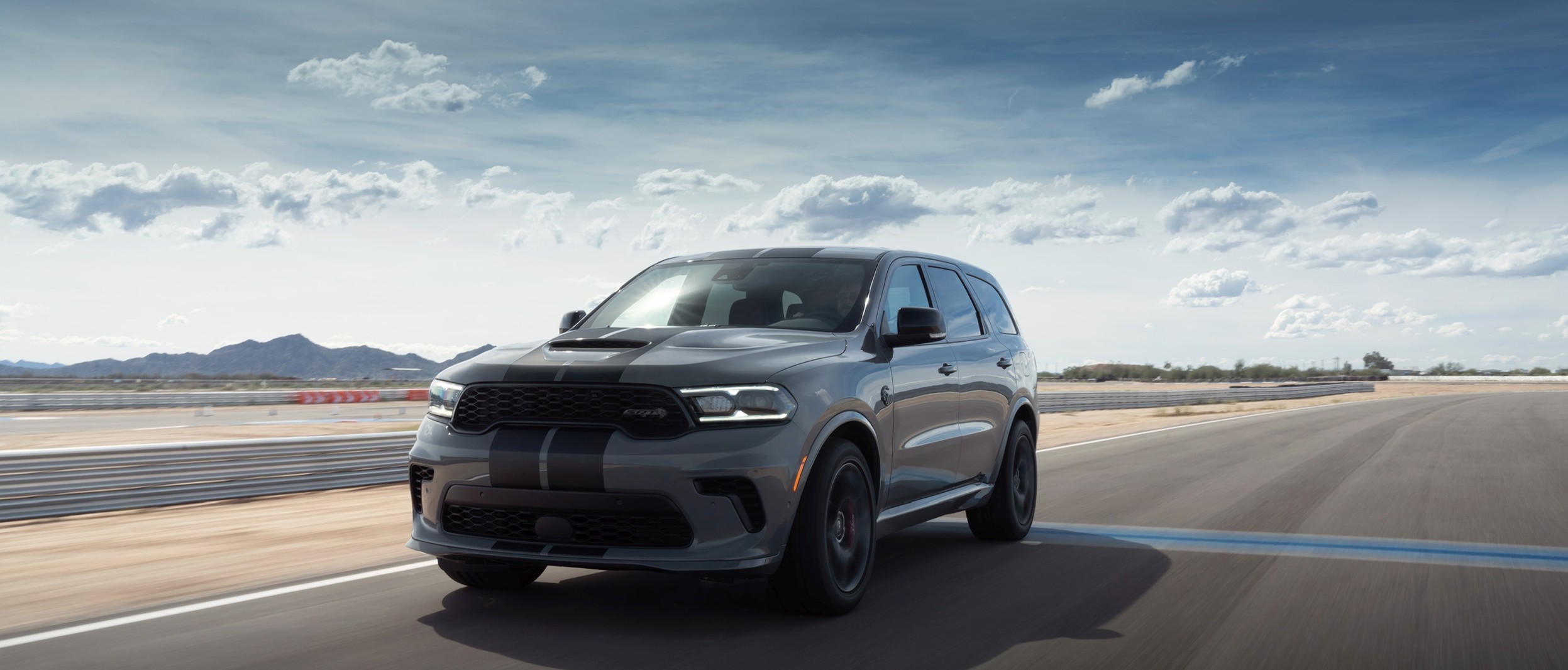 Gray 2021 Dodge Durango driving on a race track.