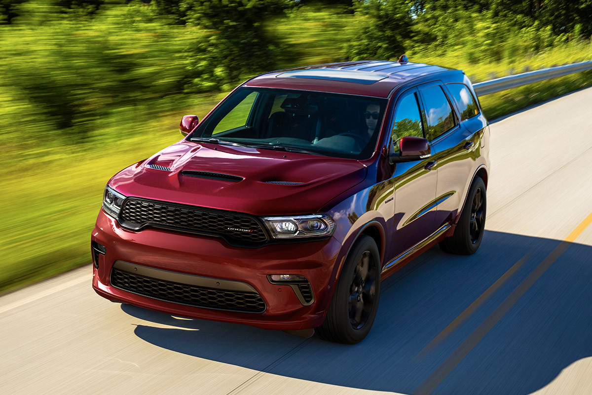 Exterior view of a red 2022 Dodge Durango driving down a road