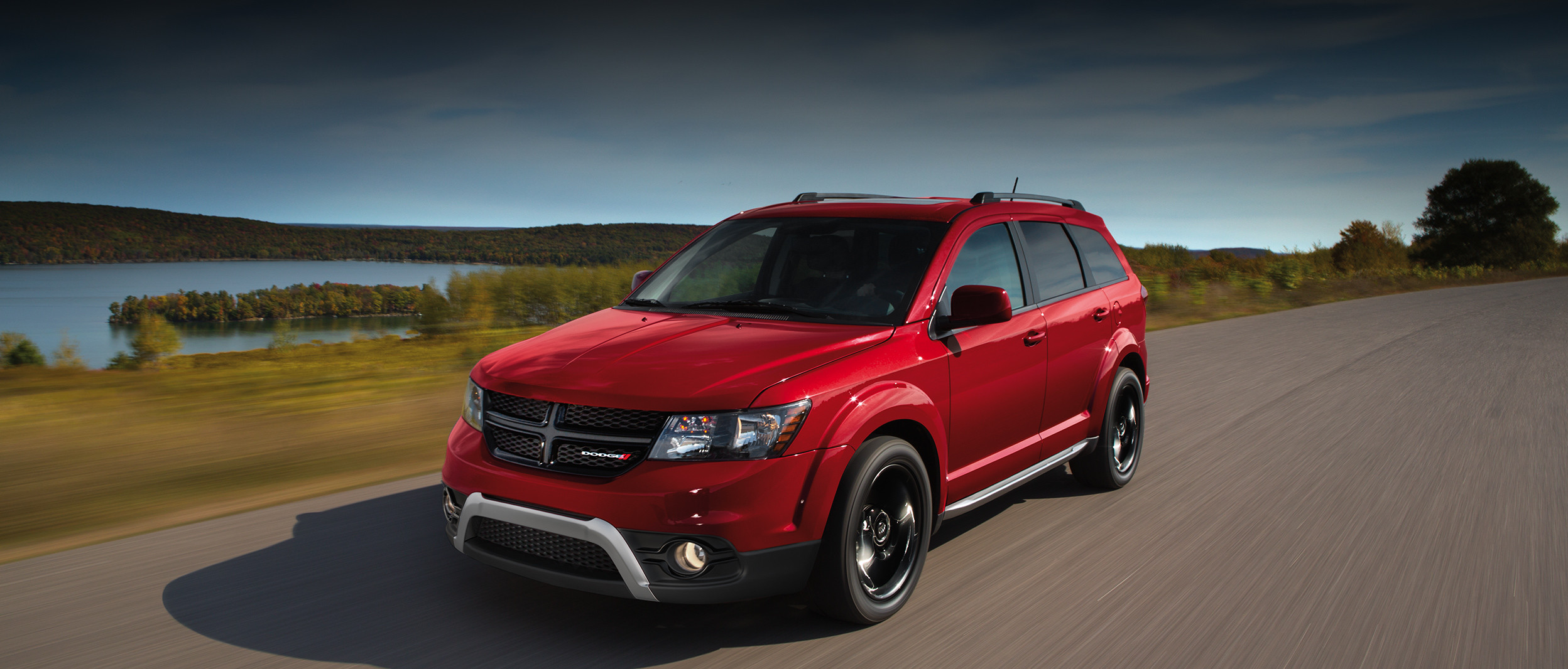 Front view of the grey 2020 Dodge Journey Crossroad driving on a road