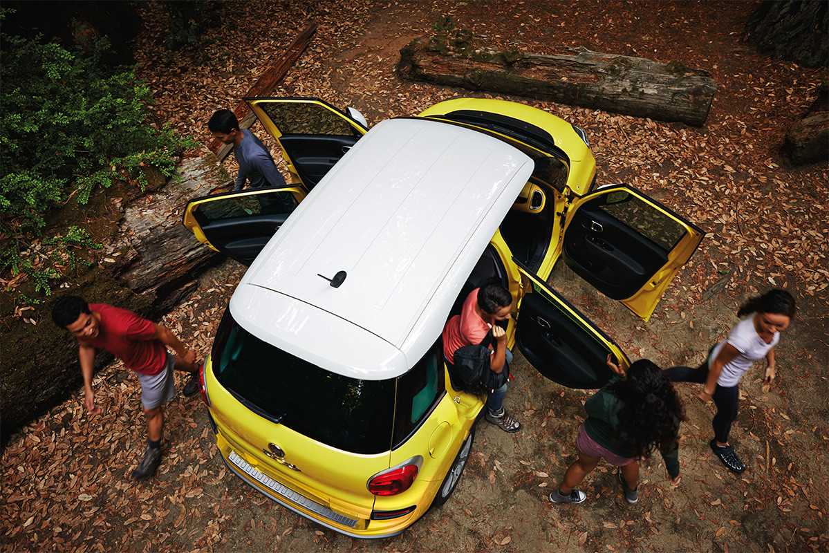Vue aérienne de la FIAT 500L 2020 garée en forêt alors que des personnes sortent du véhicule
