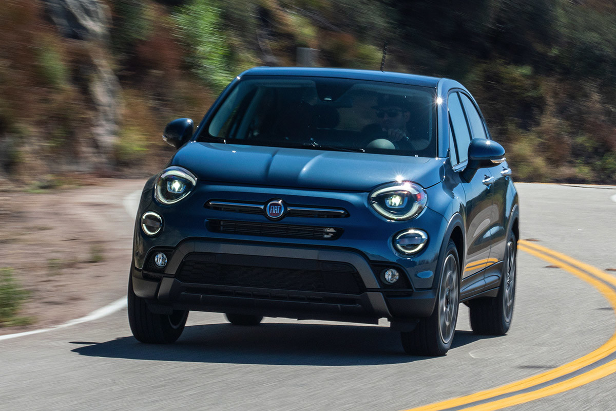 Front view of a blue 2021 FIAT 500X being driven on a curving road
