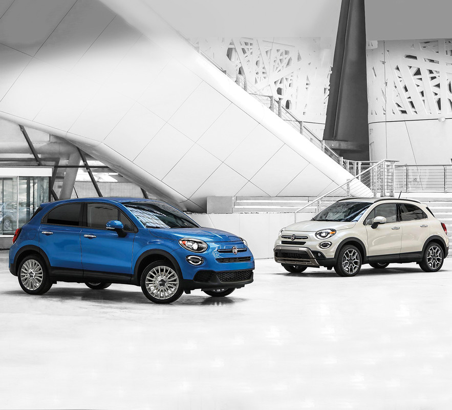 Side view of Blue 2019 FIAT 500X and White 2019 FIAT 500X inside a building
