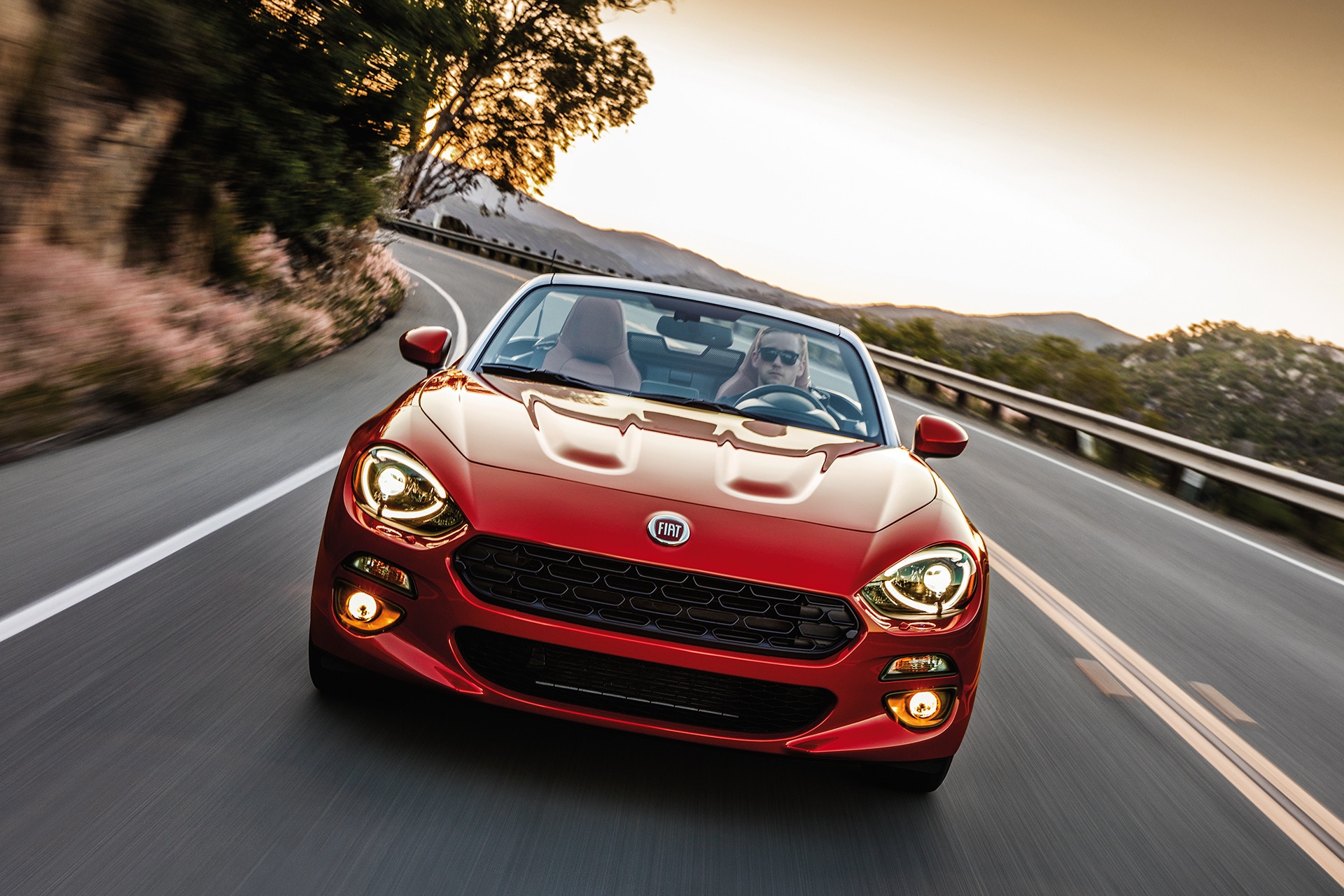 2019 Fiat 124 Spider front view driving down highway, shown in red