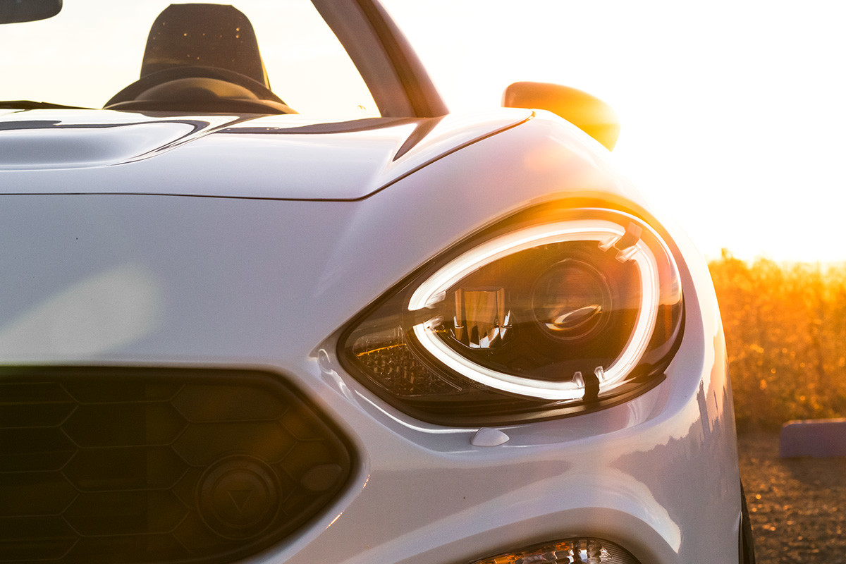 Zoomed in view of the 2020 FIAT 124 Spider LED headlight during sunset