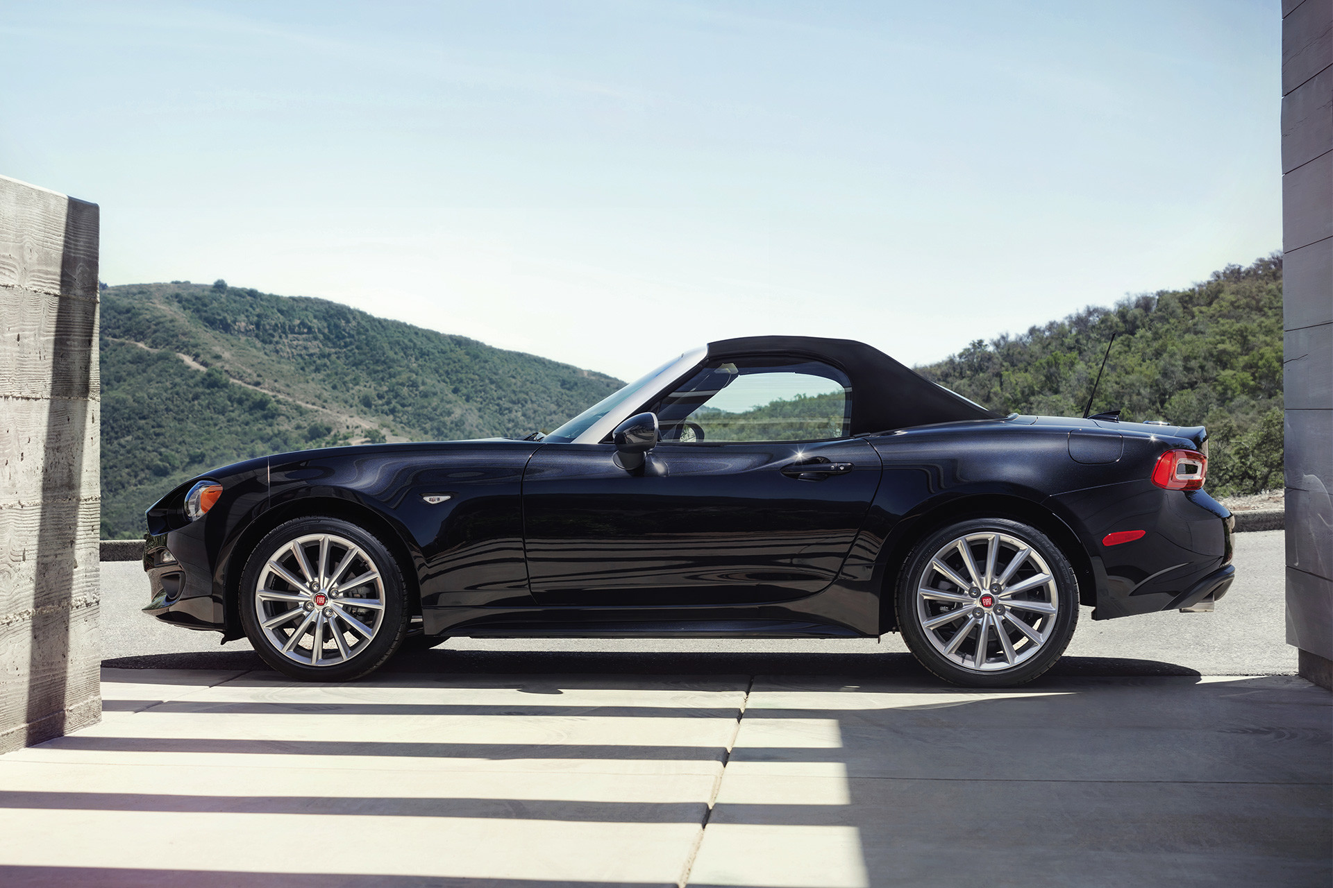 Side view of the 2020 FIAT 124 Spider parked on an outside parking lot