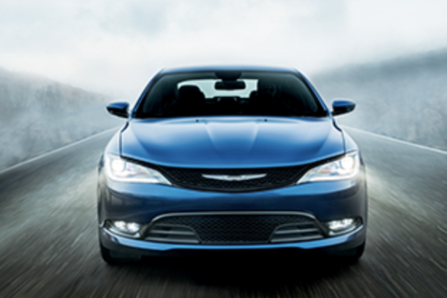 A blue Chrysler Pacifica being driven down the road.