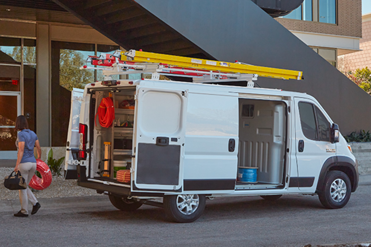 A 2023 Ram Promaster in front of a building.