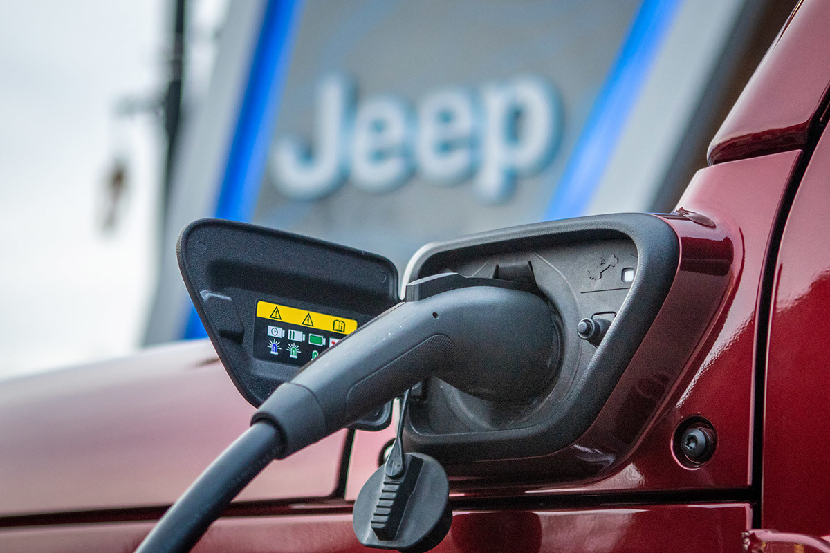 Close up of charger plugged into a red 2022 Jeep Wrangler 4xe.