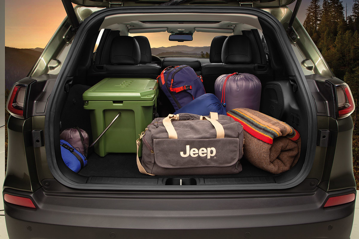 Close up of the 2021 Jeep Cherokee, showing the spacious rear storage compartment filled with travel bags and outdoor gear.