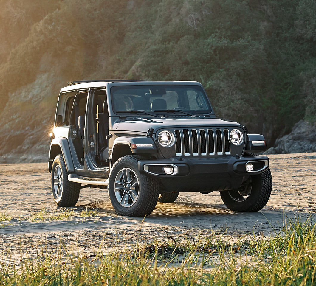 Black 2020 Jeep Wrangler, with no doors, parked on a dirt road