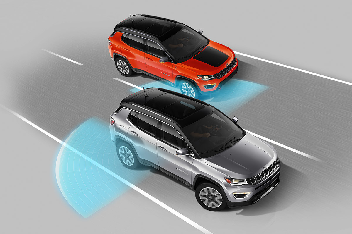 Silver 2020 Jeep Compass showcasing its Blind-Spot Monitoring system.