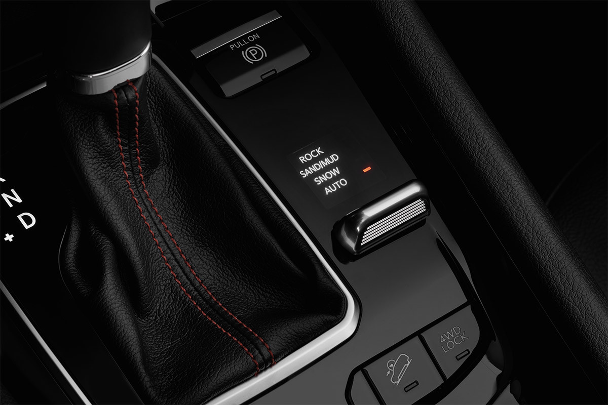 A close up on the selec-terrain traction management system inside the 2022 Jeep Compass.