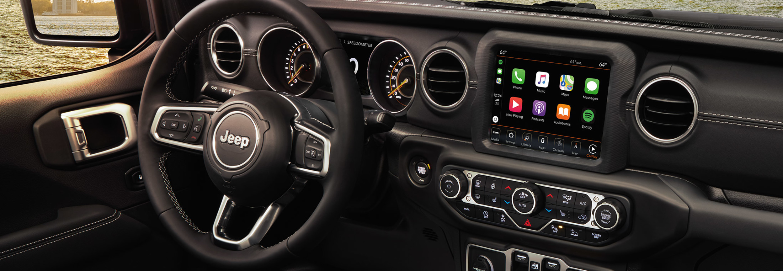 Interior view of a Jeep Gladiator including the steering wheel and entertainment system
