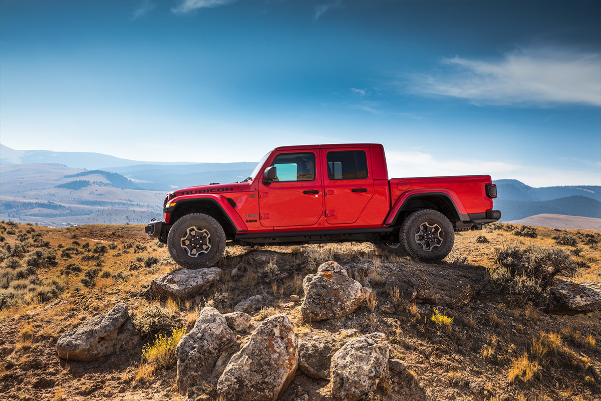 Extérieur du Jeep Gladiator 2020 roulant sur de grands rochers, illustré en rouge.