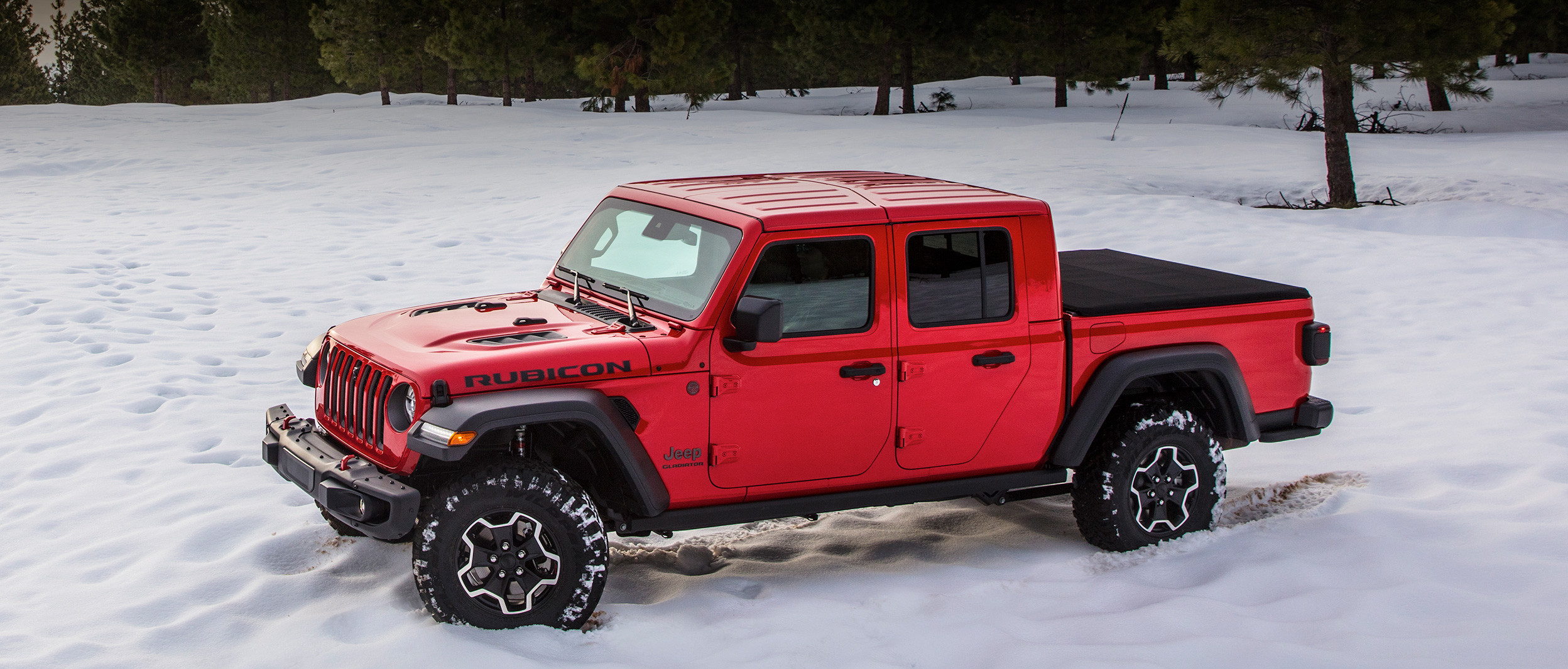 Top-down view of the all-new 2020 Jeep Gladiator in red parked in a snow covered field