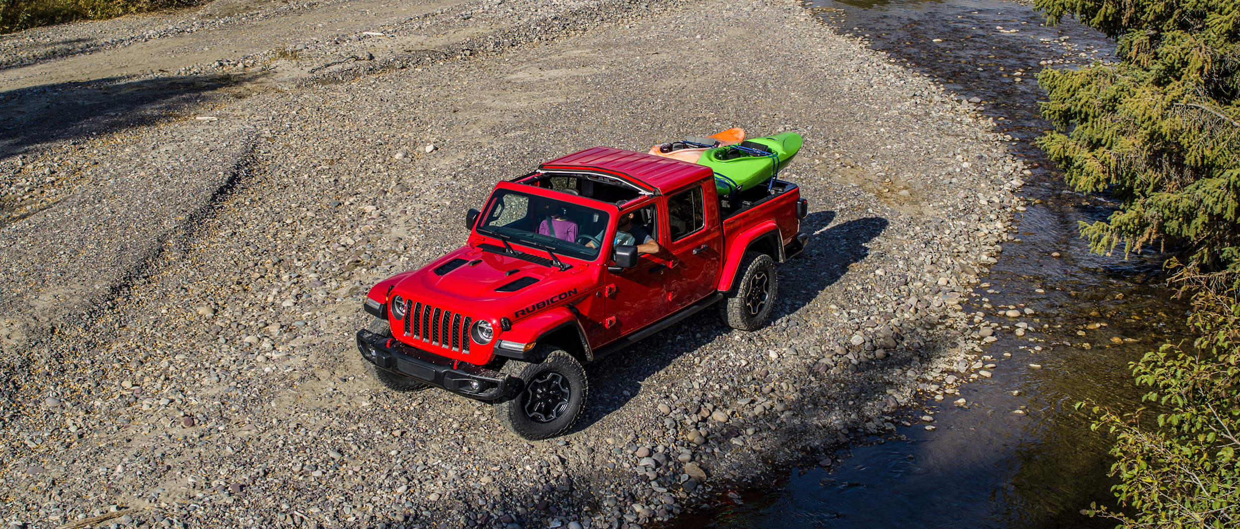 2020 Jeep Gladiator red exterior parked beside a stream