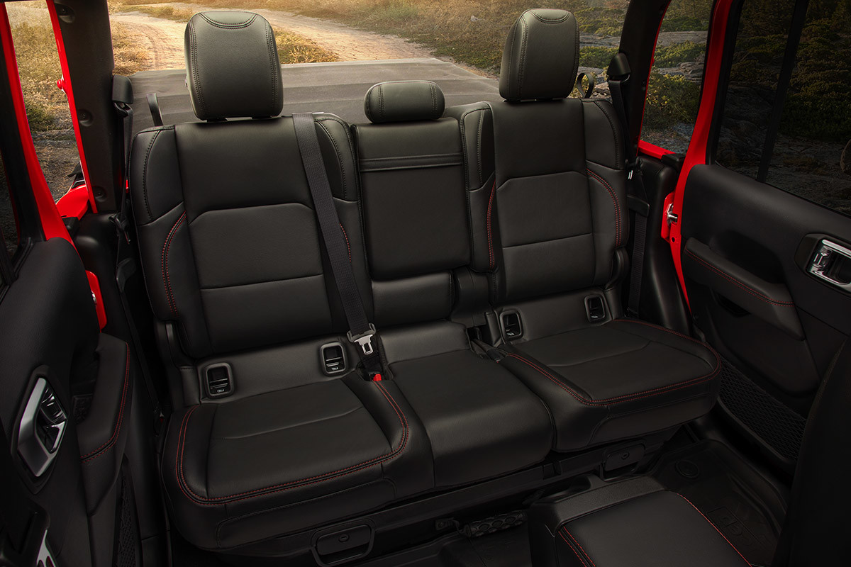 Shot of Jeep Gladiator back-row leather-faced seats with red accent stitching.