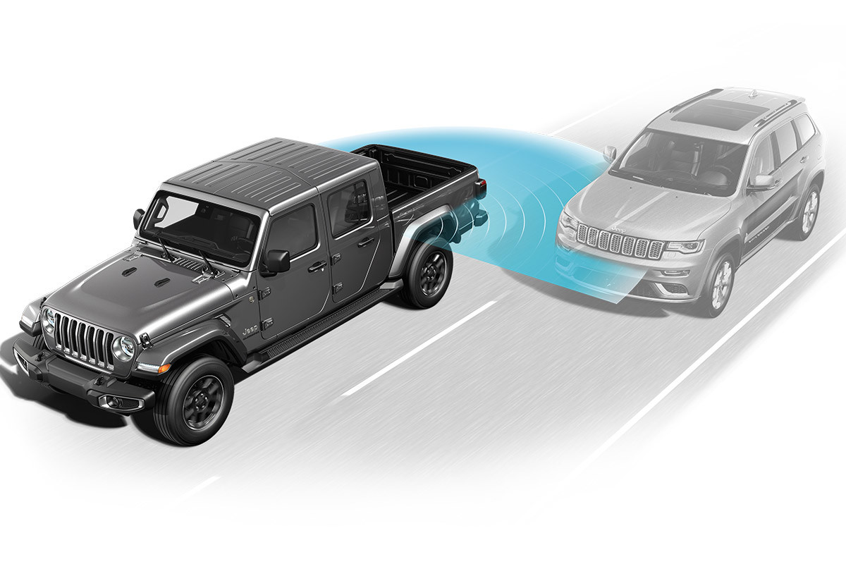Illustration du Jeep Gladiator montrant comment le système de surveillance des angles morts détecte un autre véhicule dans son angle mort.