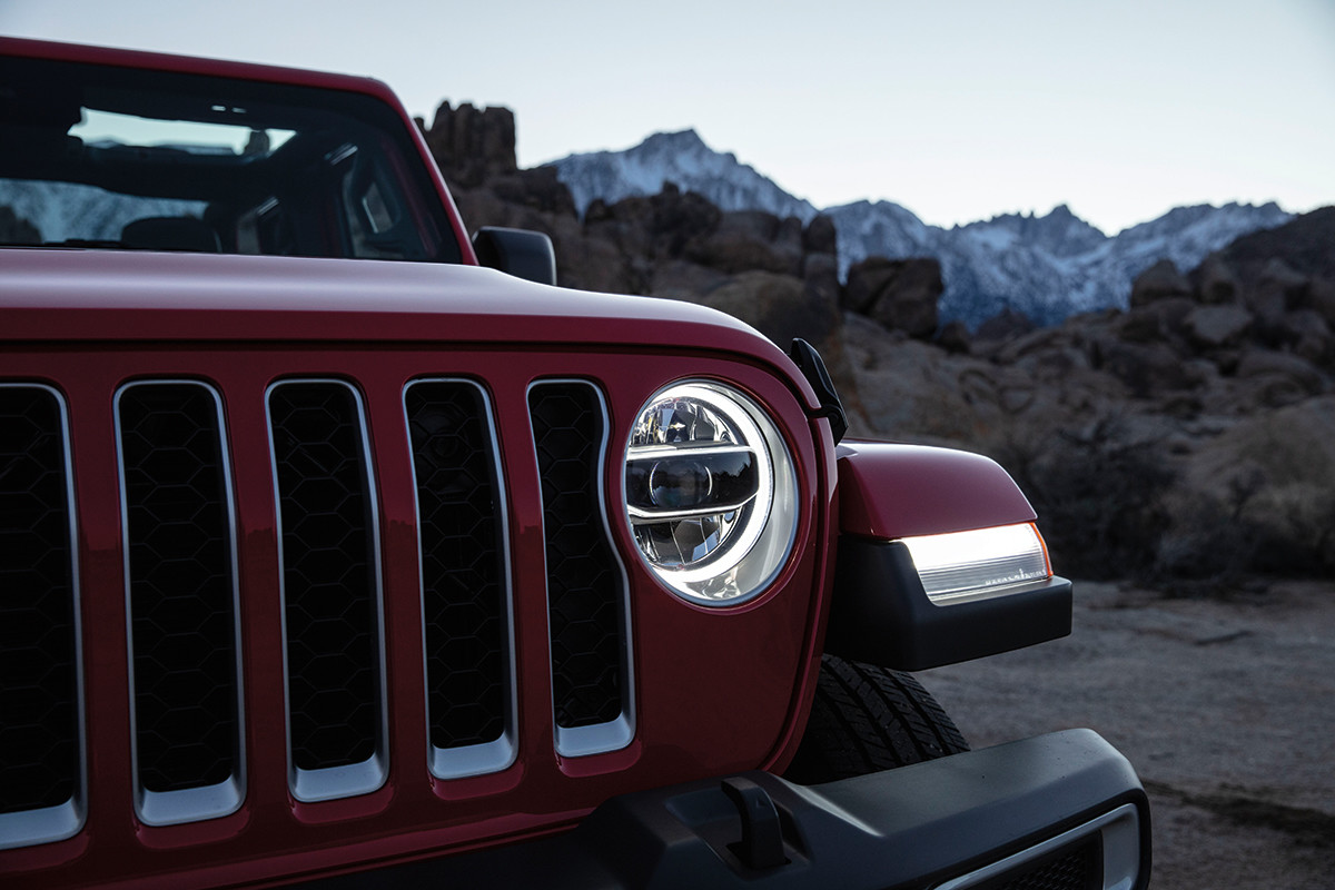 The front of a red 2022 Jeep Gladiator featuring the front LED lights.