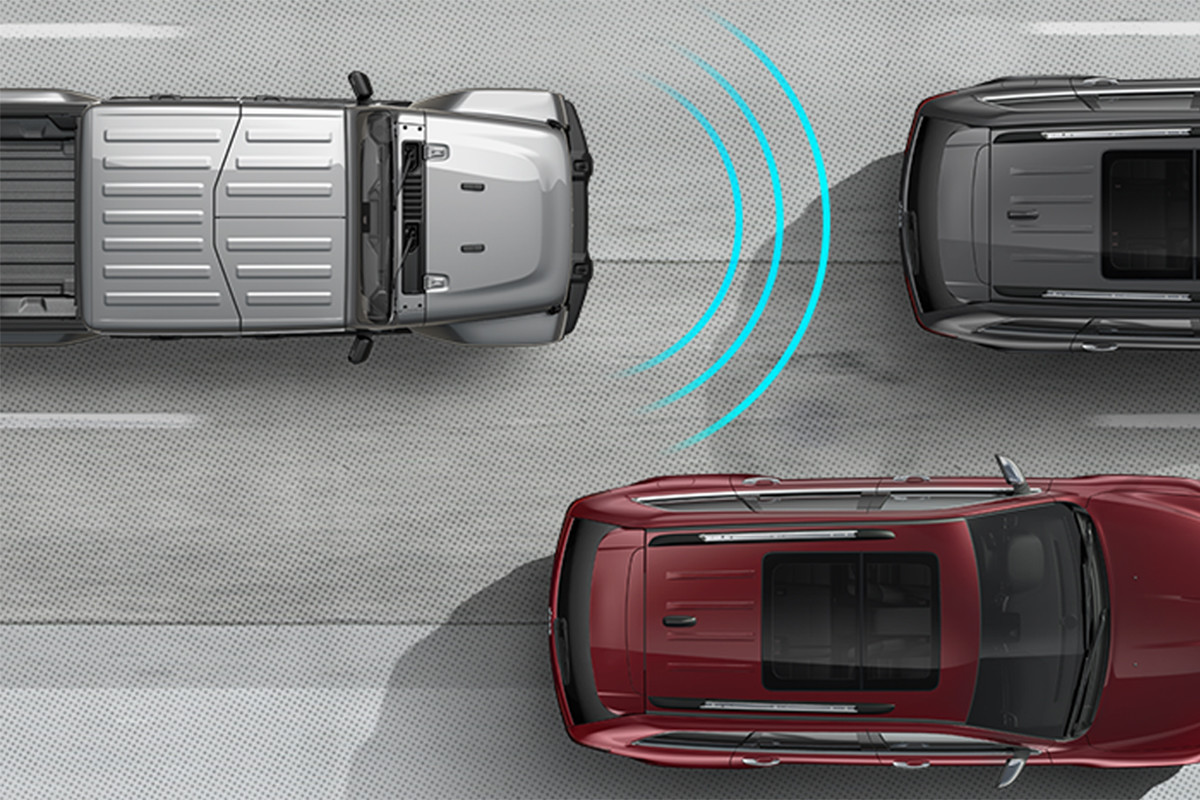 A 2022 Jeep Gladiator driving with two vehicles in front of it and a radar shape showing the forward collision warning.