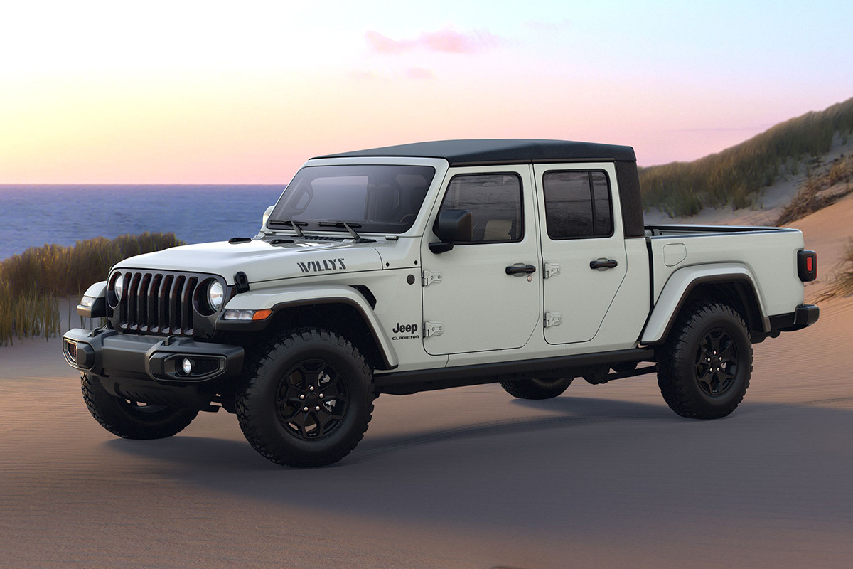 A white 2022 Jeep Gladiator Willys parked on a sandy landscape.