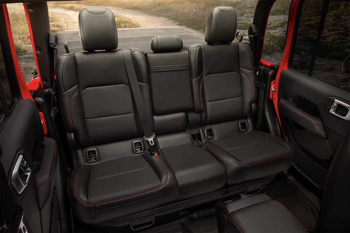 Shot of Jeep Gladiator back-row leather-faced seats with red accent stitching.