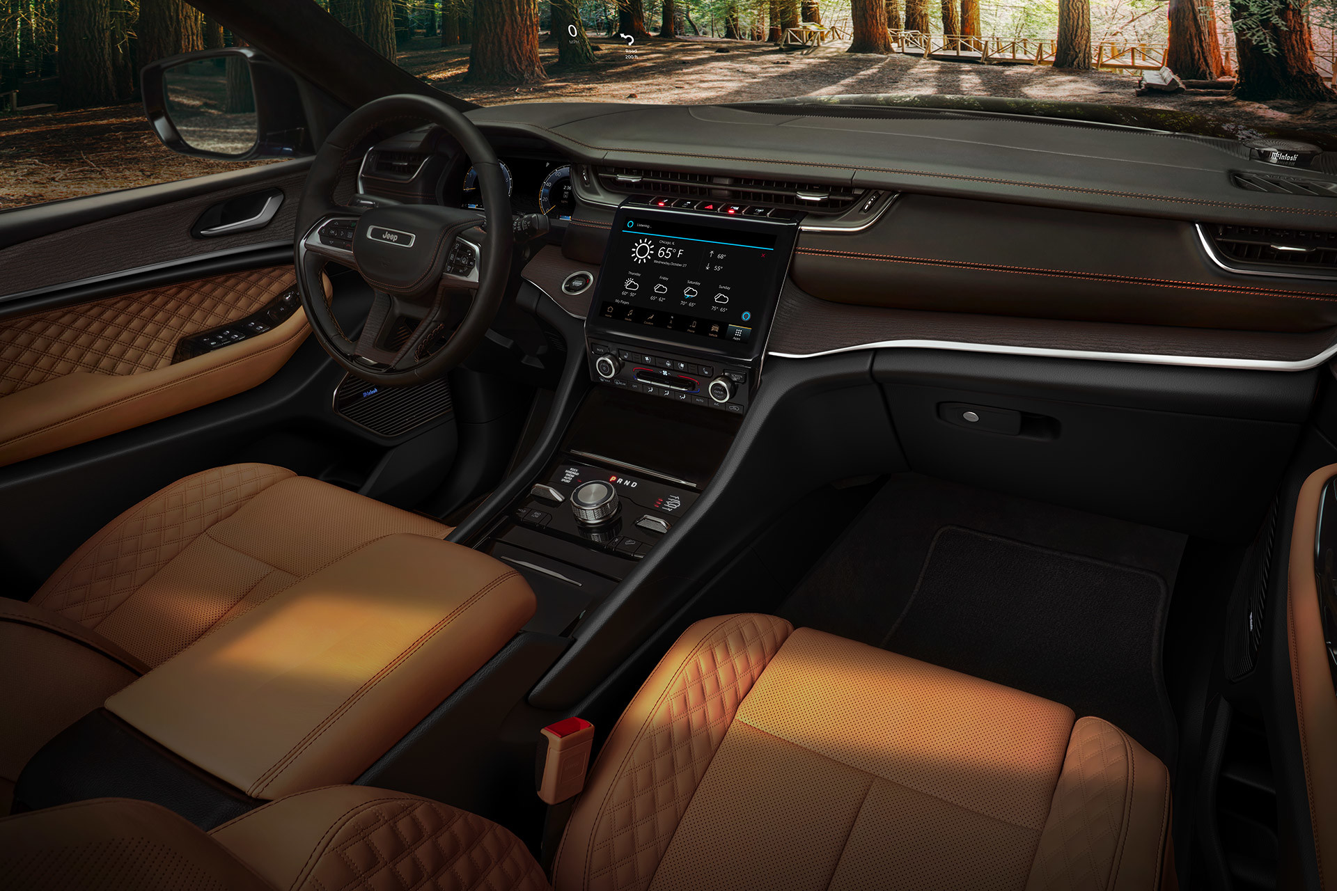 The interior of a 2022 Jeep Grand Cherokee, with the driver’s and passenger’s sides being shown.