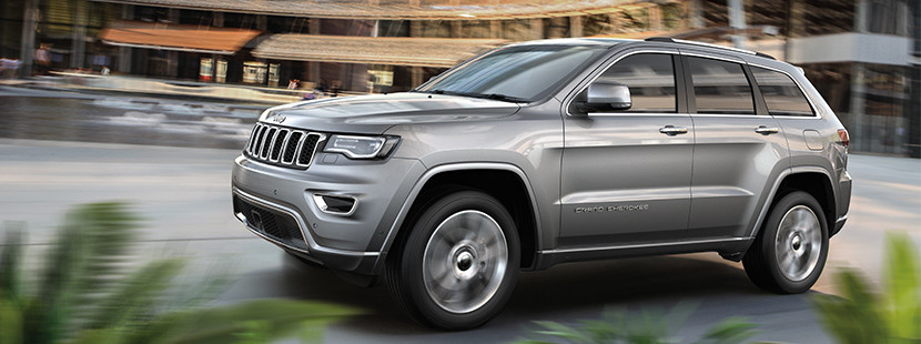 Silver 2018 Jeep Grand Cherokee Driving Through the Streets of the City