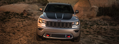2019 Jeep Grand Cherokee in silver driving over rocks