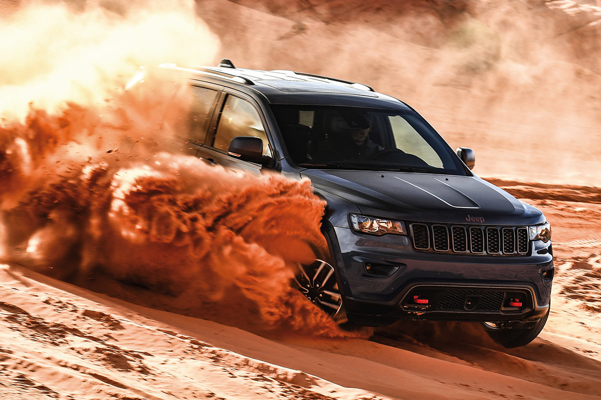 Grey 2020 Jeep Grand Cherokee being driven through a desert.