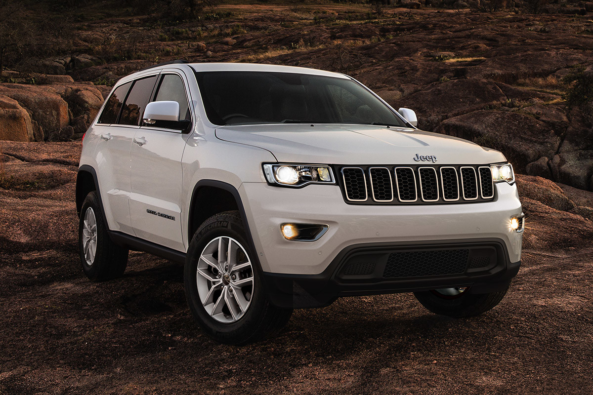 Silver 2020 Jeep Grand Cherokee parked in a desert.