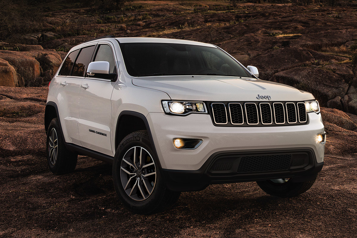 White 2020 Jeep Grand Cherokee, parked on top of rocky plains.