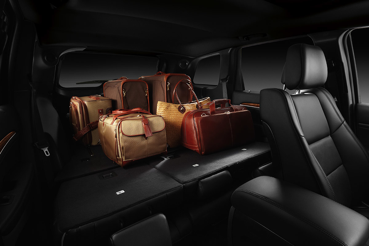 Bags stored in the back of a Jeep Grand Cherokee with its rear seats folded down for maximum cargo space.
