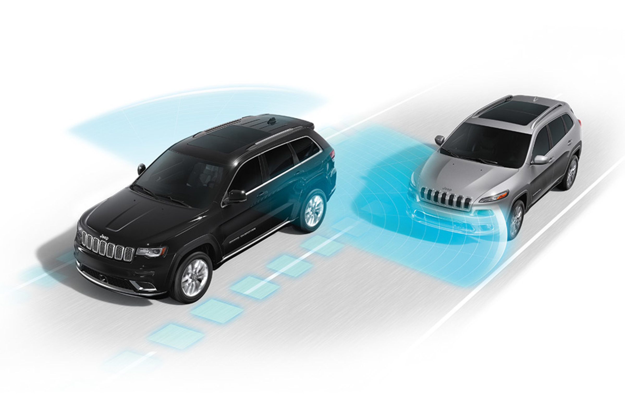 An overhead view of a grey-coloured 2021 Grand Cherokee drifting out of its lane towards a black-coloured 2021 Grand Cherokee. Illustrated blue sensors representing the available Lane Departure Warning with Lane Keep Assist systems emanate from the front of the grey vehicle.