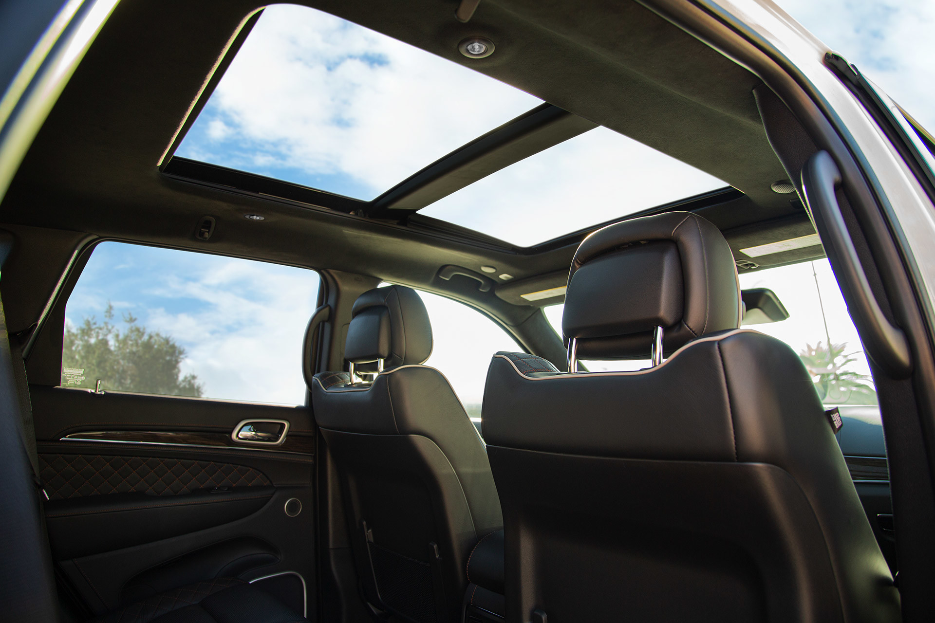 Jeep Grand Cherokee interior showing an open sunroof.