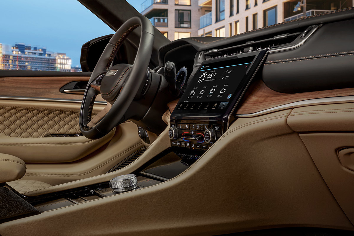 A view of the driver seat from the passenger side, inside the 2022 Jeep Grand Cherokee