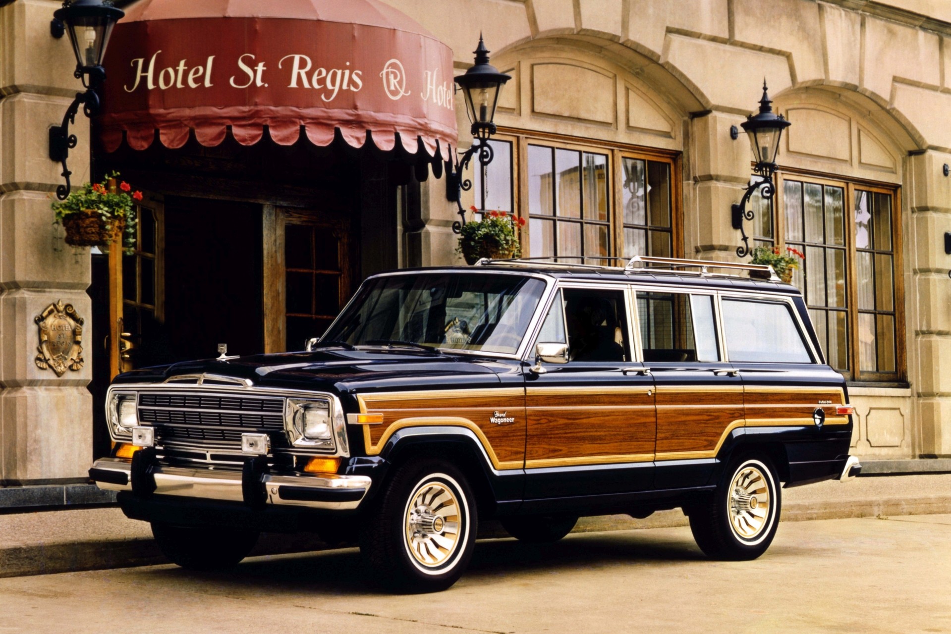1986 Grand Wagoneer parked in front of a hotel.