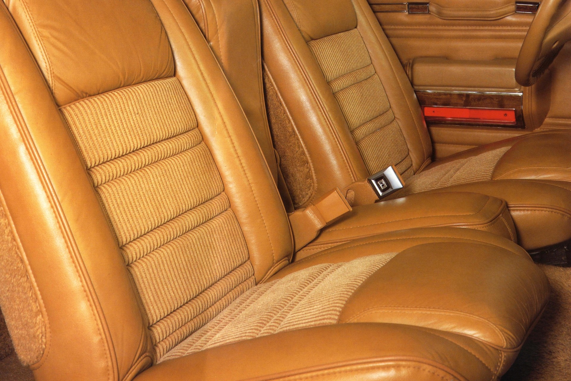 The interior of a Grand Wagoneer featuring beige leather and fabric seats.