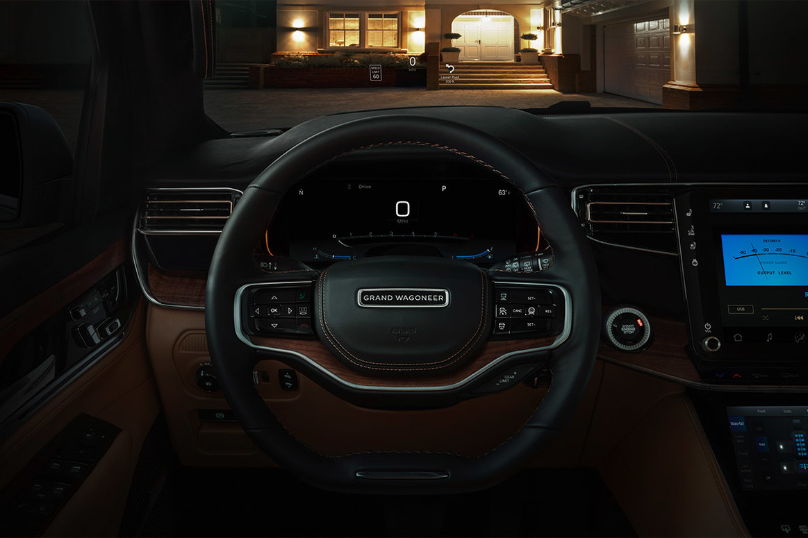 The driver’s side of an All-New 2022 Grand Wagoneer, with the steering wheel and dashboard being showcased.