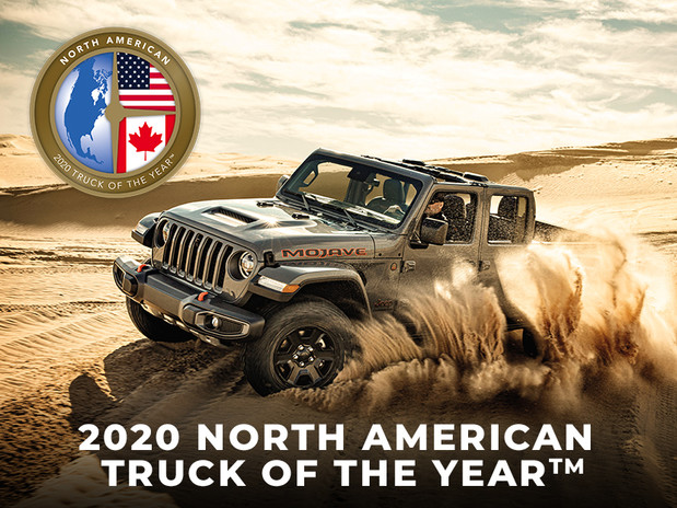 Grey 2020 Jeep Gladiator being driven through the desert.