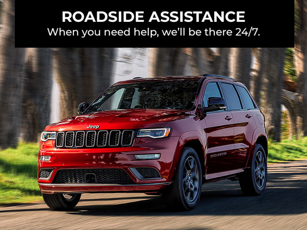 Roadside assistance. We’re here 24/7 to help when you need it. Red 2020 Jeep Grand Cherokee being driven on the road.