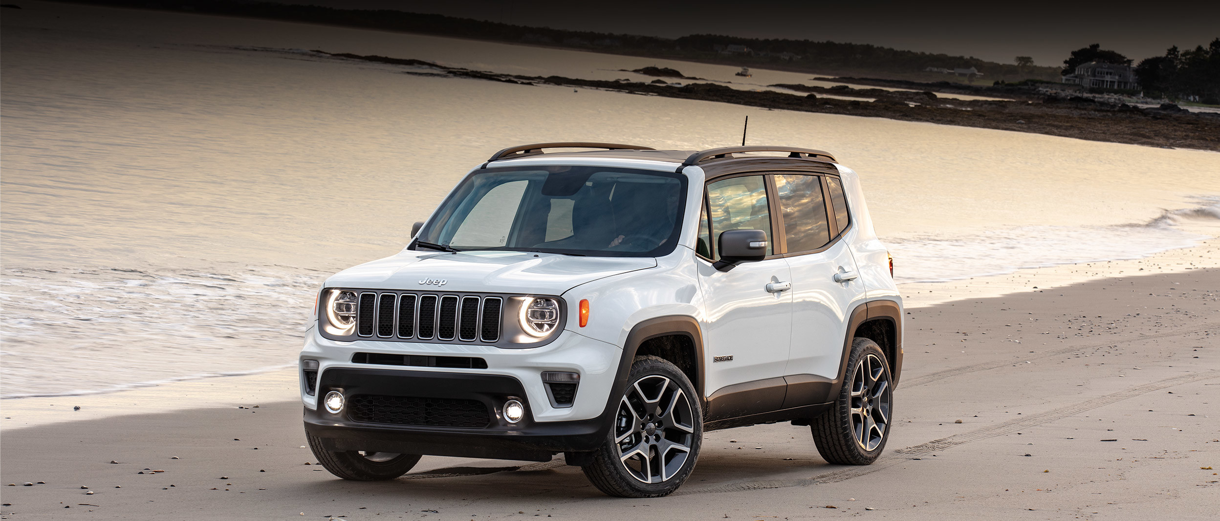 White 2019 Jeep Renegade, parked on a beach shoreline.