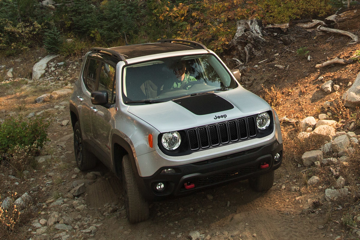 2020 Jeep Renegade being driven on a dirt road through rocks and trees in a mountain