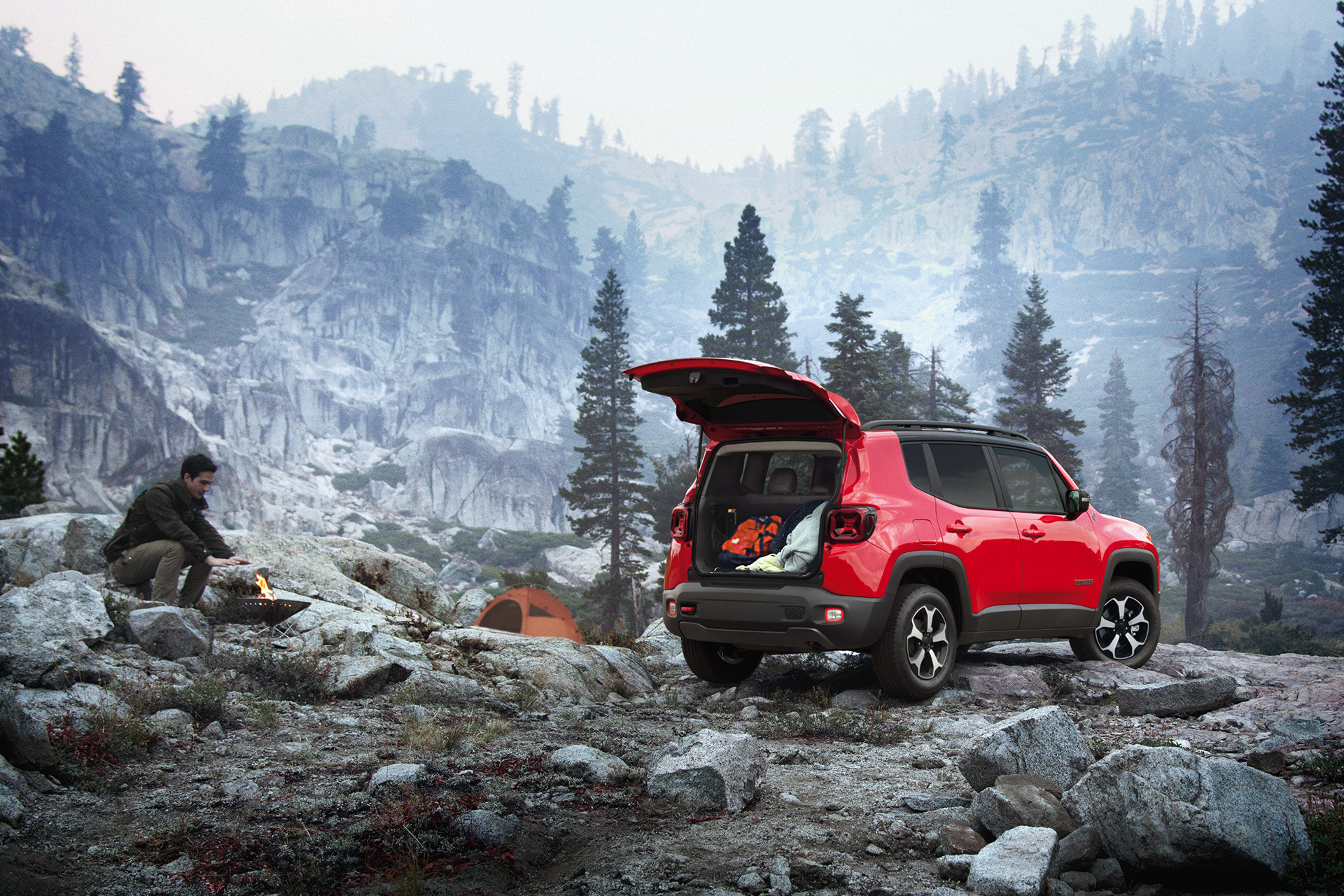 Red 2020 Jeep Renegade parked outdoors in rock mountain with tailgate opened