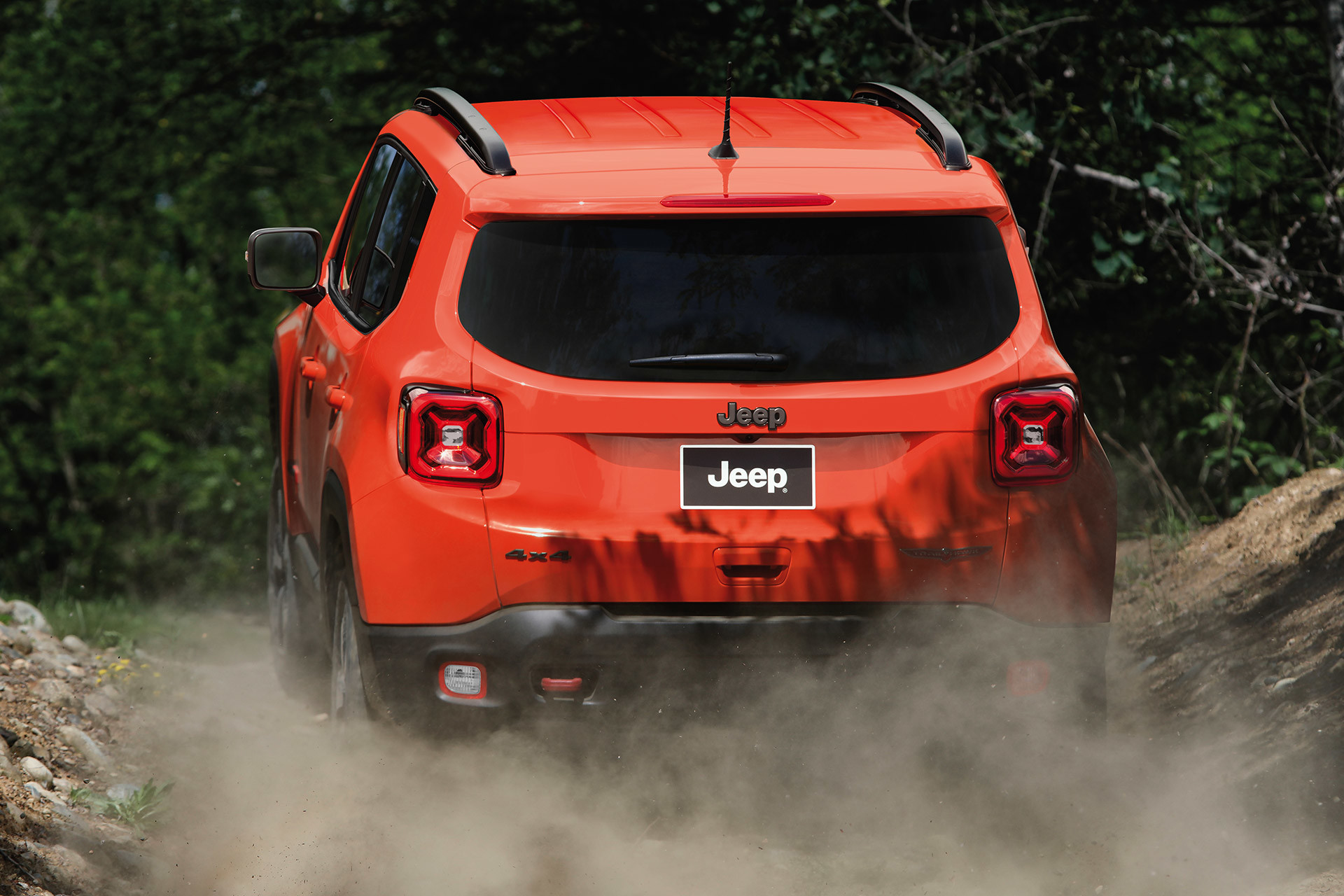 Rear view of 2020 Jeep Renegade being driven on offroads through plains