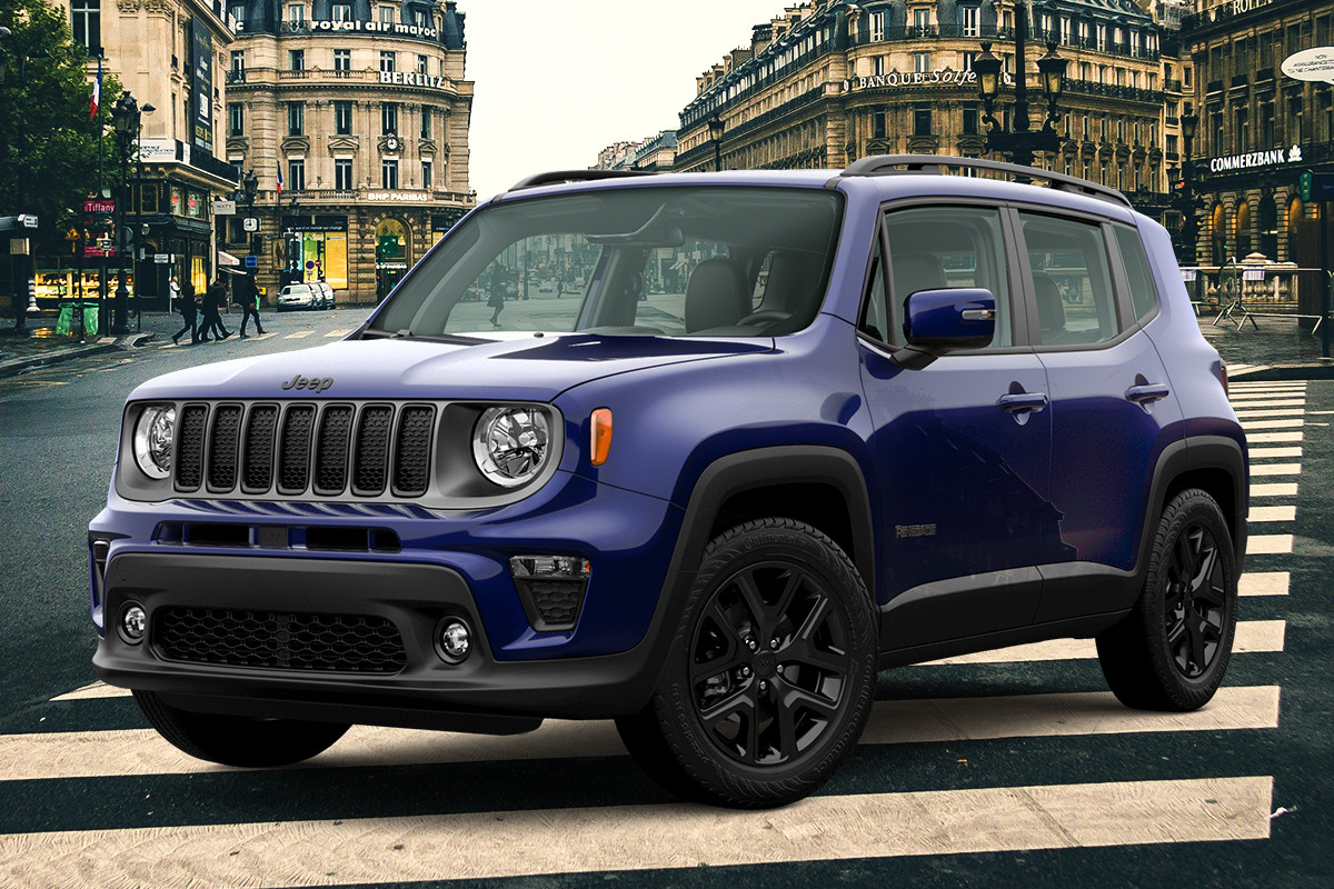 Blue Jeep Renegade parked on a city street with buildings in the background.