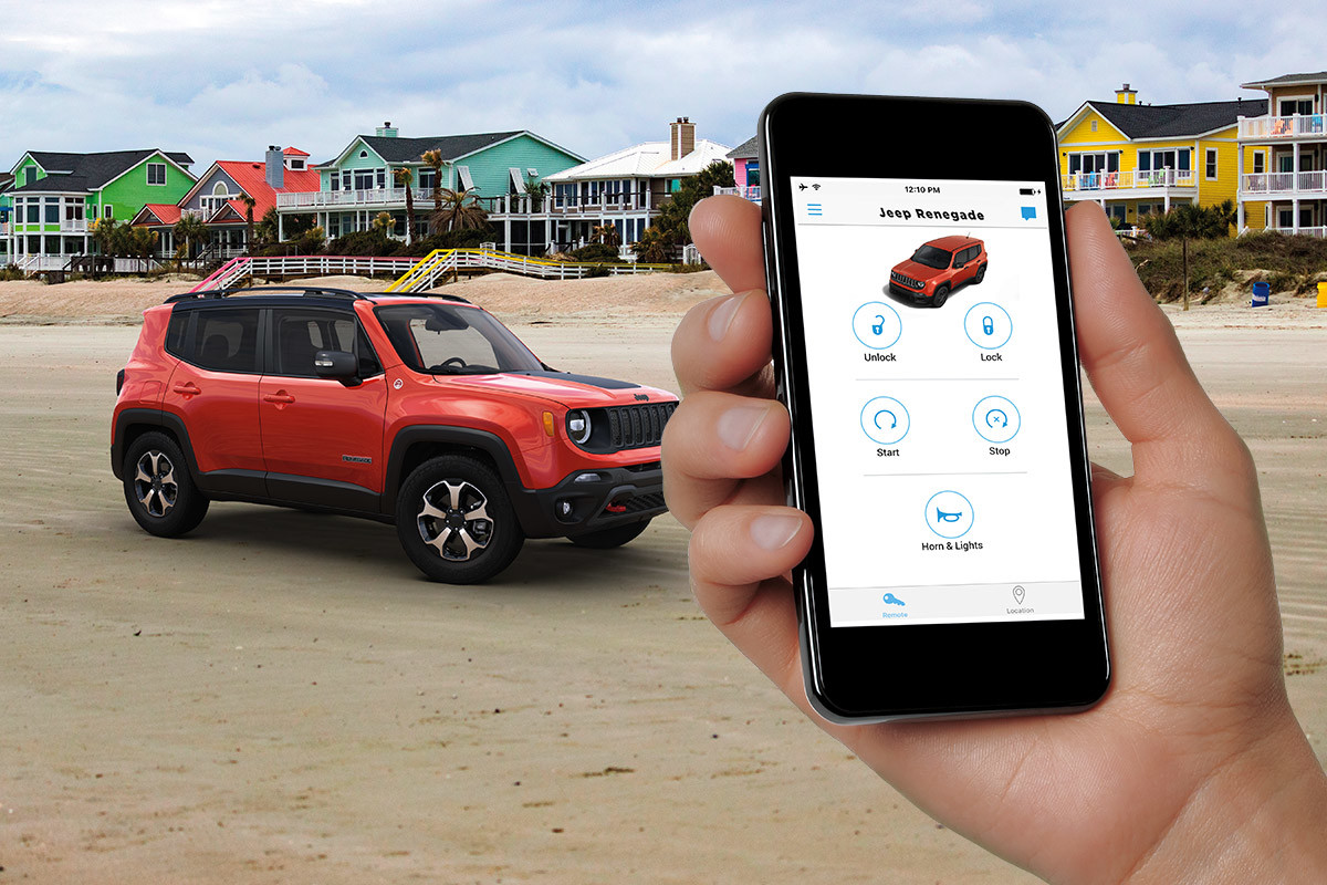 Orange Jeep Renegade parked on a beach, with a row of colourful beach house properties in the background.