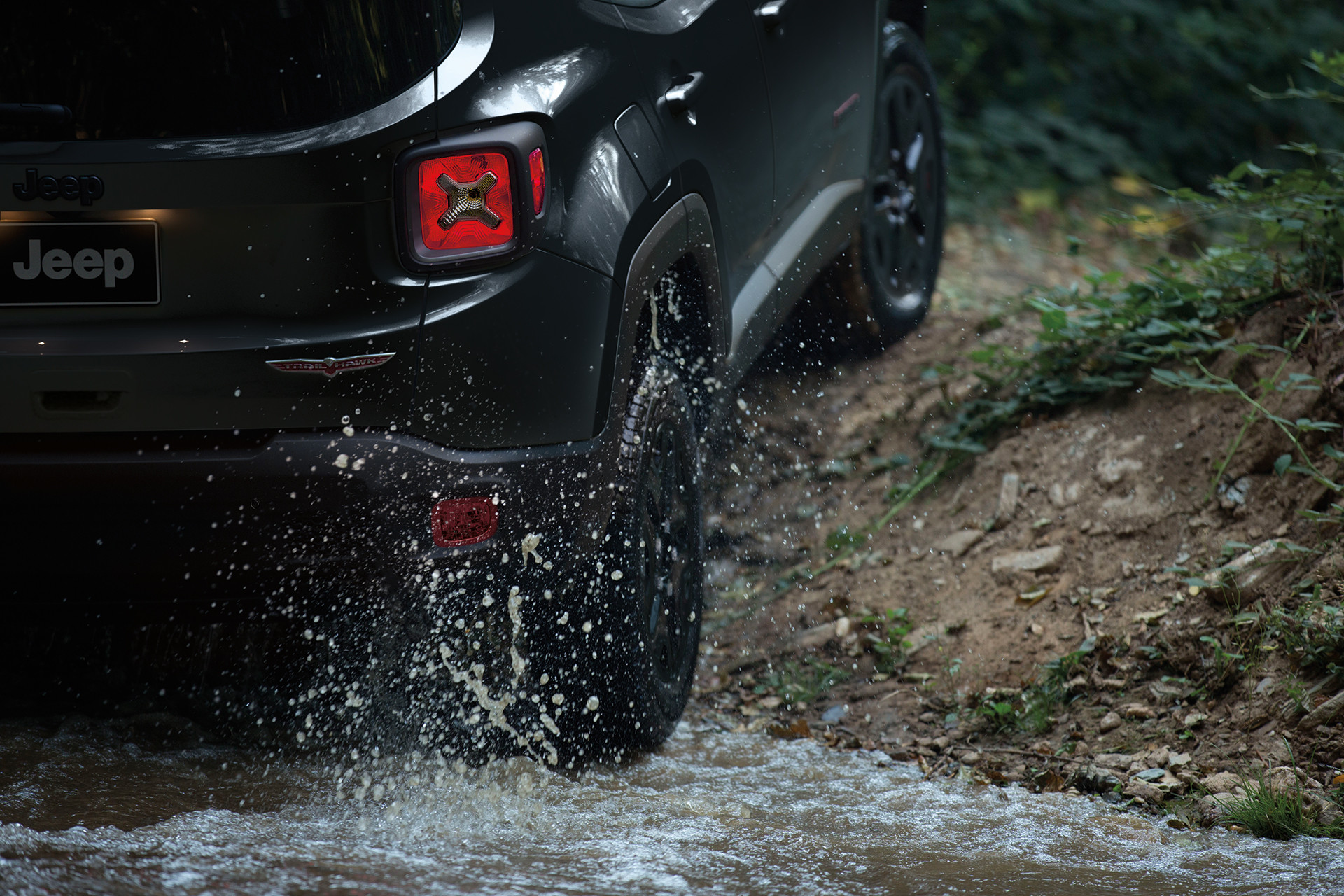 Close up of the tires of a black 2022 Jeep Renegade.