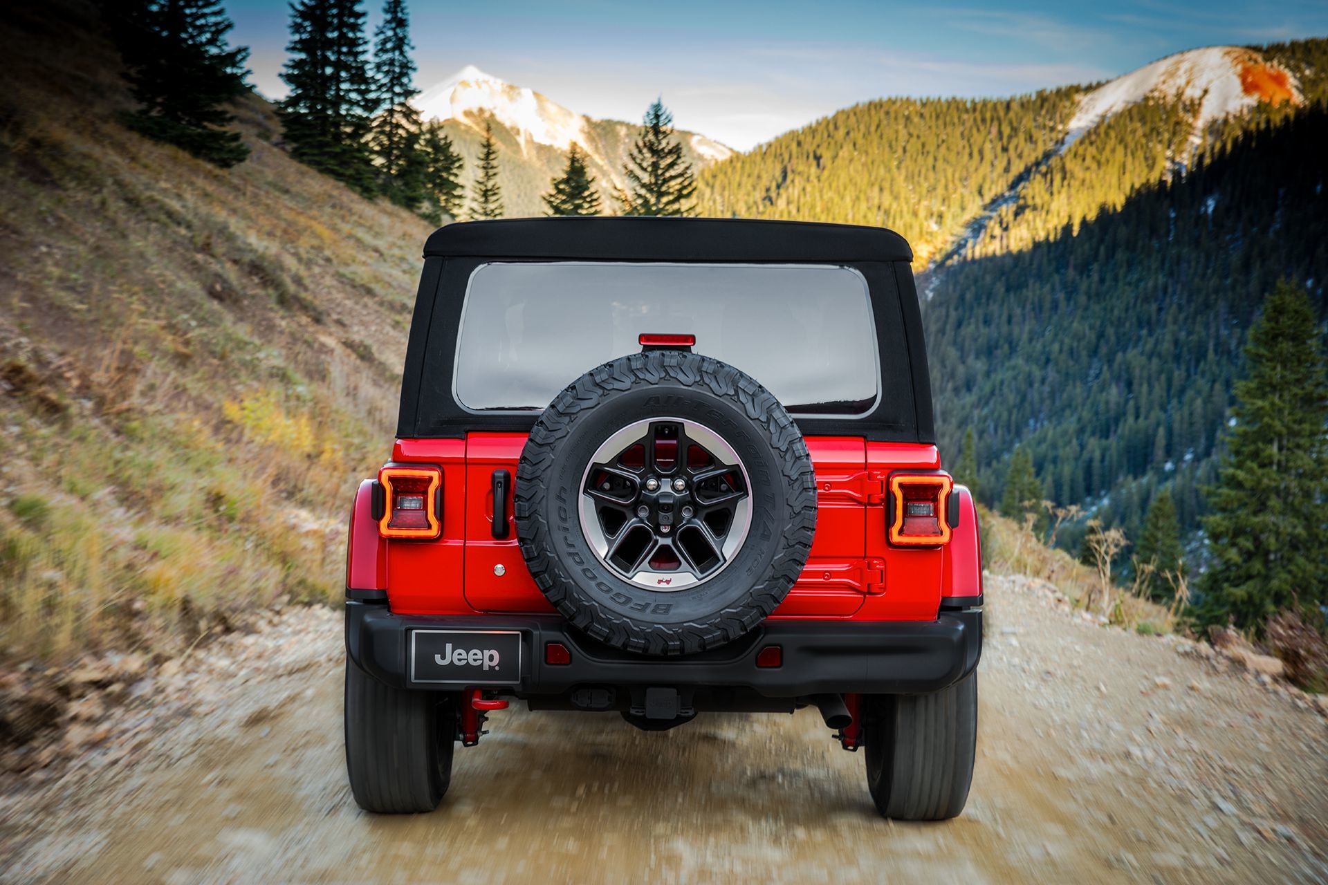 2018 Jeep Wrangler JL Rubicon rear tire, shown driving through mountains